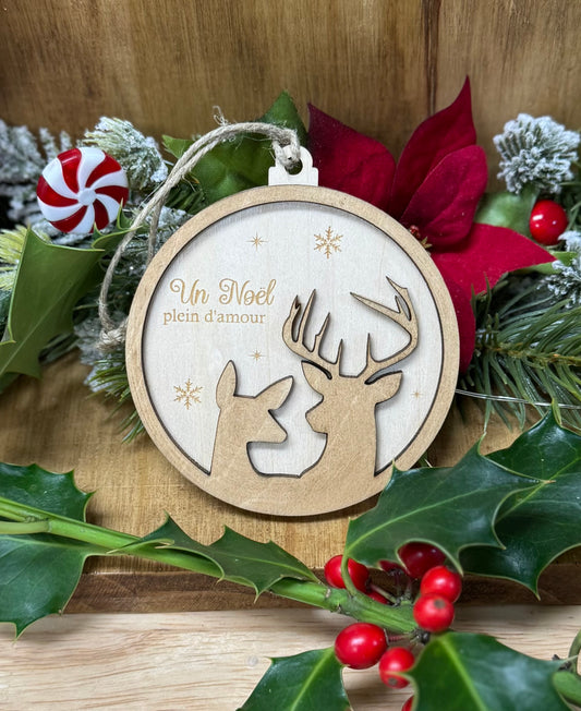 Boule de Noël en bois avec deux cerfs qui se regardent; gravure : un Noël plein d'amour